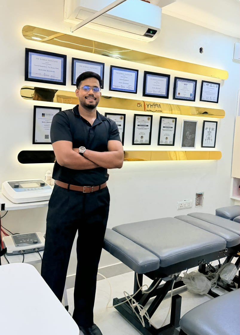 Dr. Rahul Bhandari, Lead Physiotherapist at Symphysio, standing with arms crossed in the clinic